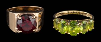 A 9 carat gold garnet ring,: the circular cut garnet claw set on a wide shank,