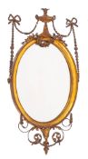 A giltwood and composition framed oval wall mirror in Neoclassical style, circa 1900,