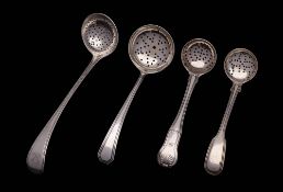 Four assorted silver sifting spoons, various makers and dates: monogrammed,