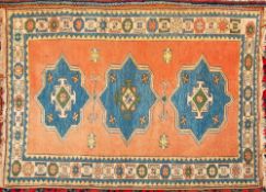 A Turkish rug:, the rose field with triple indigo stellar medallions,