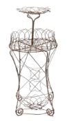 A painted wirework plant stand, early 20th century,: of openwork form, with a raised and dished top,