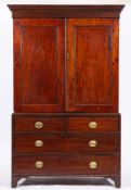 A George III mahogany linen press, circa 1800,: with dentilled cornice above twin panelled doors,