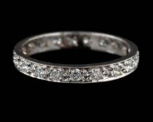 An 18 carat gold and diamond eternity ring,: set with brilliant cut diamonds,