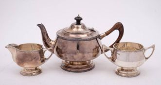 A George V silver three-piece circular tea service, maker Walker & Hall, Sheffield,