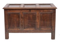 An oak coffer, mid 17th century,: the hinged three panel lid with moulded front and side edges,