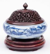 A Chinese blue and white tripod censer: of compressed globular form, painted with buildings,