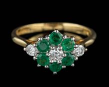 An 18 carat gold emerald and diamond ring,