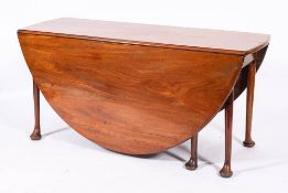 A George II mahogany gateleg dining table, circa 1740,: the oval top with twin drop leaves,