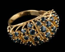 A sapphire ring,: the domed ring set with circular cut sapphires, with ropetwist panels in between,