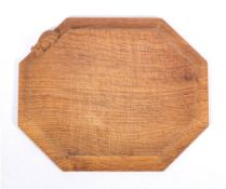 Workshop of Robert 'Mouseman' Thompson (Kilburn), an English oak bread board,: of octagonal form,