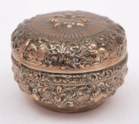 An Indian silver circular box and cover: with embossed animal and foliate decoration, 9.