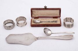 A mixed lot of silver wares: includes Swiss silver slice, three napkin rings and two teaspoons,