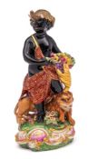 A Derby porcelain figure allegorical of Africa: modelled as a blackamoor in elephant headdress