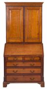 A late George III oak, mahogany crossbanded and chequer inlaid bureau cabinet, early 19th century,