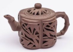A Chinese yixing 'bamboo' teapot and cover: of reticulated double-walled form, seal marks, 8cm high.