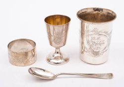 A German silver christening set, stamped marks: includes cup, spoon and napkin ring,