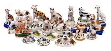 A group of twenty two porcelain figures of dogs: primarily Continental gold anchor and German