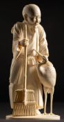 A Japanese carved ivory okimono of a beaded smiling man,