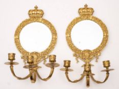 A pair of Victorian gilt metal and mirror glass girandoles: the circular bevelled mirror plate