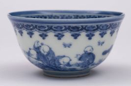 A Chinese blue and white 'boys' bowl: painted with five boys playing in a garden with a pine tree