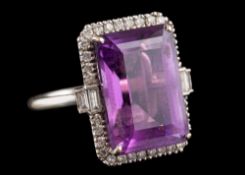 An 18 carat gold amethyst and diamond dress ring: the central rectangular step cut amethyst