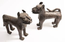 A pair of 20th century Benin bronze models of leopards: standing on all fours with ears pricked,