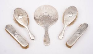 A George V silver five piece hammered silver backed dressing table set, maker Charles Fox & Co Ltd,