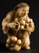 A Japanese carved ivory netsuke, signed Nanryu: of a man trimming a bonsai,