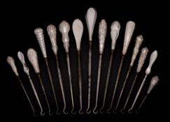 A collection of fifteen assorted silver-handled button hooks,