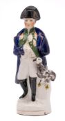 A Staffordshire pottery portrait figure of Napoleon: modelled standing in military uniform with an