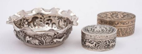 An Indian silver sugar basin: of circular form with embossed jungle scenes, 10cm diameter,