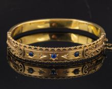 An Edwardian 9ct gold hinged bangle with rose-cut diamonds and mixed-cut sapphires,: Birmingham,