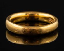 A 22 carat gold ring,: of plain polished form, stamped 22 with full Birmingham hallmarks,