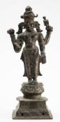 An Indian bronze four-armed figure of the standing Hindu deity Vishnu: mounted on a lotus flower