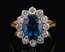 An 18ct gold, sapphire and diamond cluster ring,: the sapphire weight ca 3.