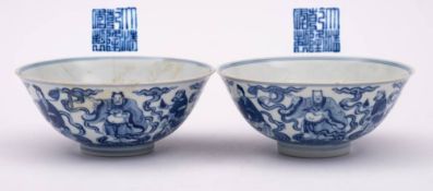 A pair of Chinese blue and white 'Eight Immortals' bowls: each exterior painted with the eight