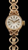Everite, a 9 carat gold lady's wristwatch,: the circular dial with black baton markers and hands,