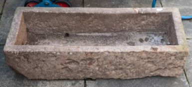 A rough hewn rectangular stone trough, 18th/ 19th century;: 25cm high, 101cm long, 41cm wide.