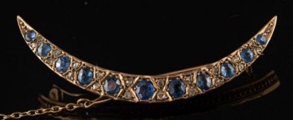 A sapphire and diamond crescent brooch:,