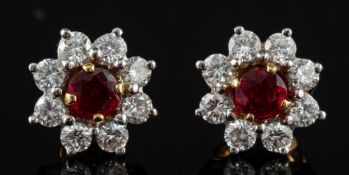 A pair of 18 carat gold ruby and diamond earrings by Garrard & Co.