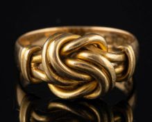 An 18 carat gold knot ring,: stamped 18 with full Birmingham hallmarks, ring size O 1/2, 6.7g.