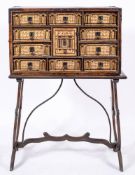 A Spanish polychrome painted and parcel gilt vargueno on stand, in 16th century style,