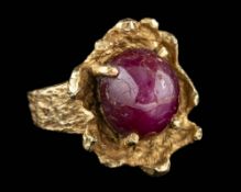 A star ruby dress ring,: the oval cabochon star ruby in a four claw setting,