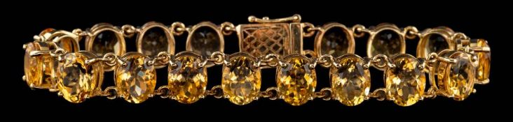 A 9 carat gold citrine bracelet,: set with oval cut citrines, to a pierced clasp,