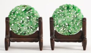 A pair of Chinese jadeite circular plaques: carved and pierced with birds amongst flowers and
