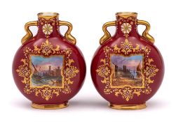 A pair of Coalport ruby ground porcelain moon flasks: of small size with gilt scroll handles,