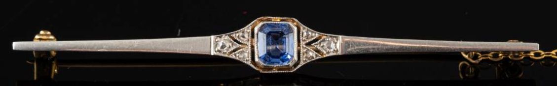 A sapphire and diamond brooch,: the rectangular cut sapphire between rose cut diamonds,