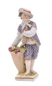 A Berlin figure of a boy emblematic of Autumn: wearing a purple striped jacket and breeches,