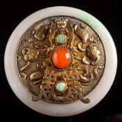 A small Chinese silver-gilt and jadeite mounted easel mirror: decorated in relief with auspicious