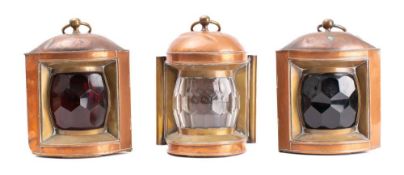 A set of three copper ships' lanterns: unsigned, comprising port, starboard and toplight,